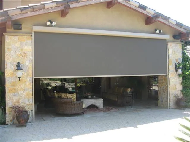 Outdoor patio with large gray roll-down shade