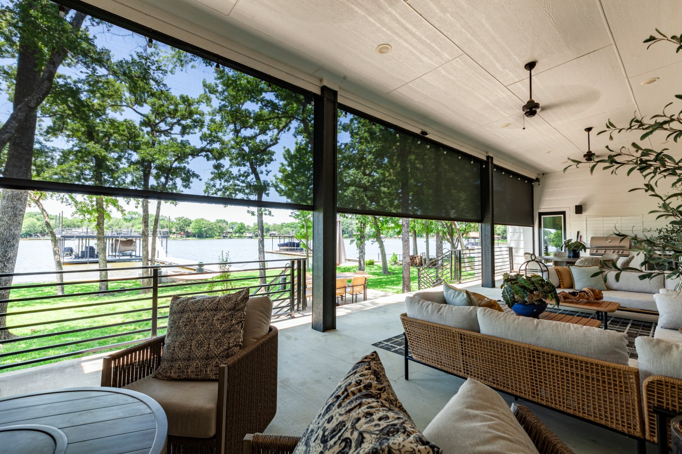 Patio with solar screen shades overlooking lake.