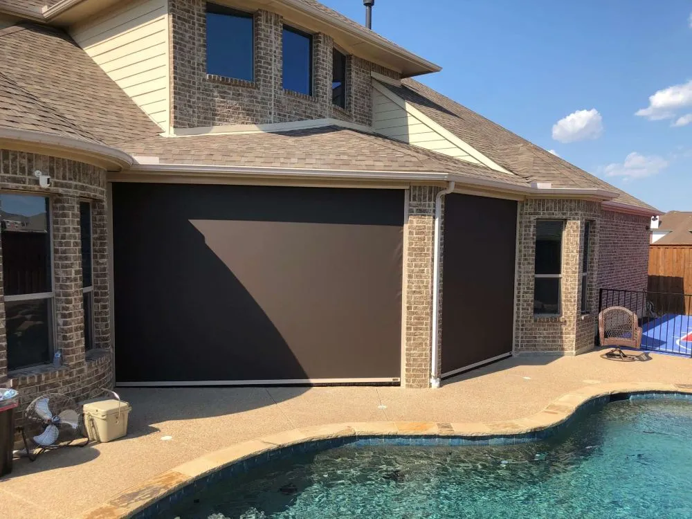 Retractable patio shades by a pool