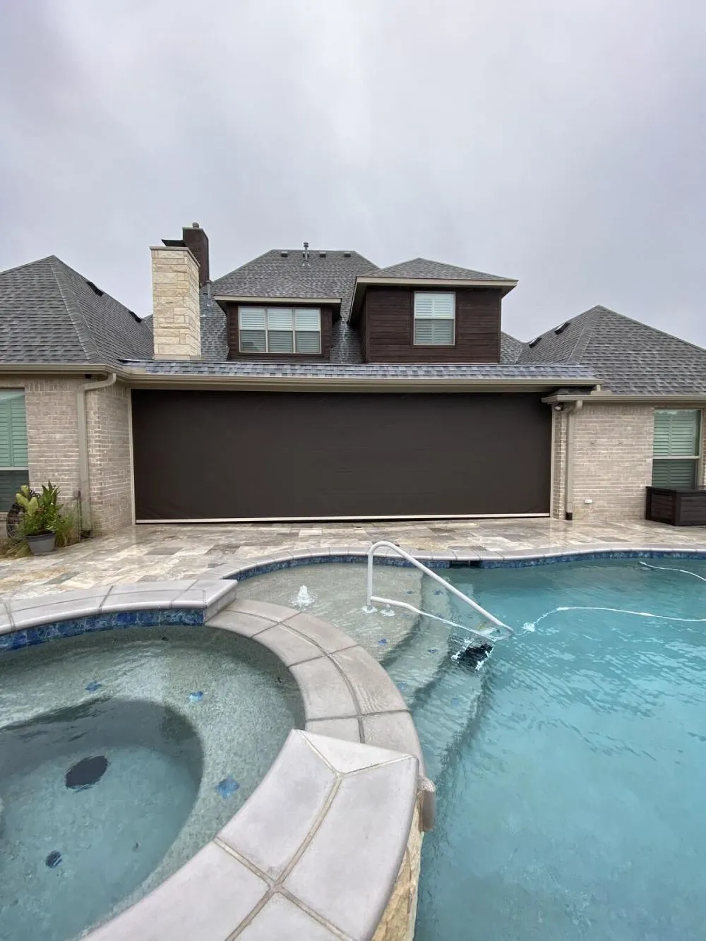 House with large poolside exterior shade