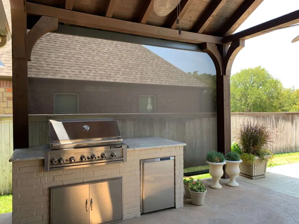 Covered outdoor kitchen protected by a rolling shutter.