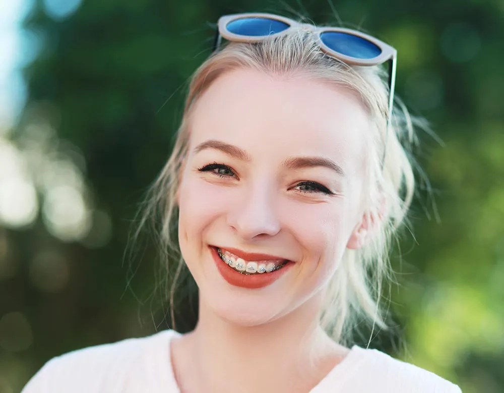 Patient smiling with braces during orthodontic treatment