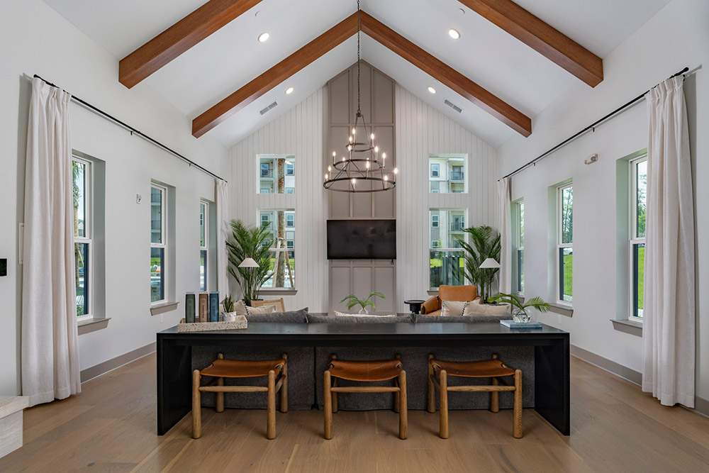 Interior photo of a room with a long table with stools underneath it.