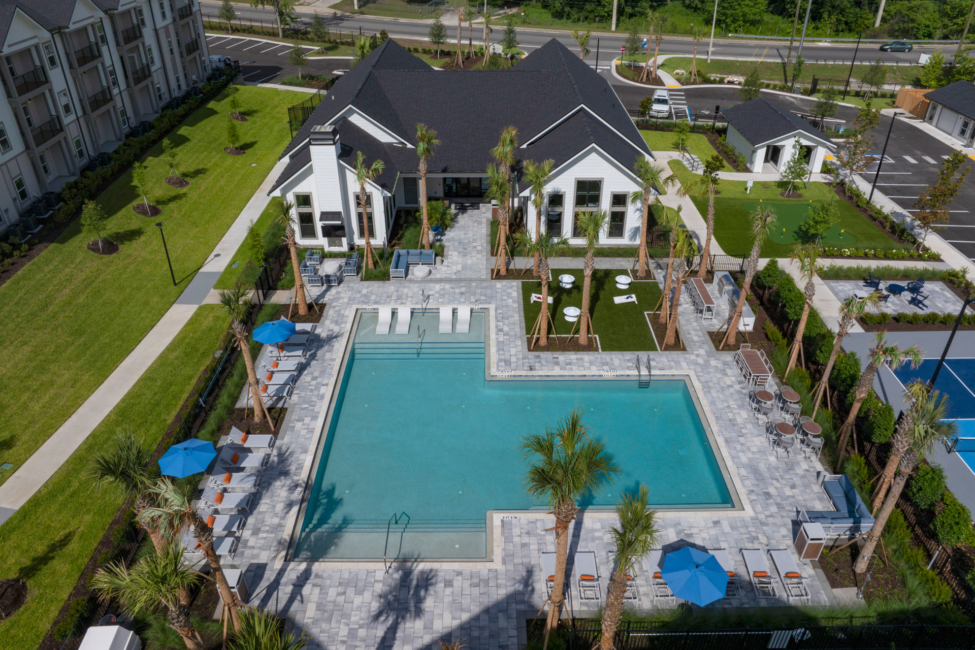 Aerial shot of a clubhouse and pool.