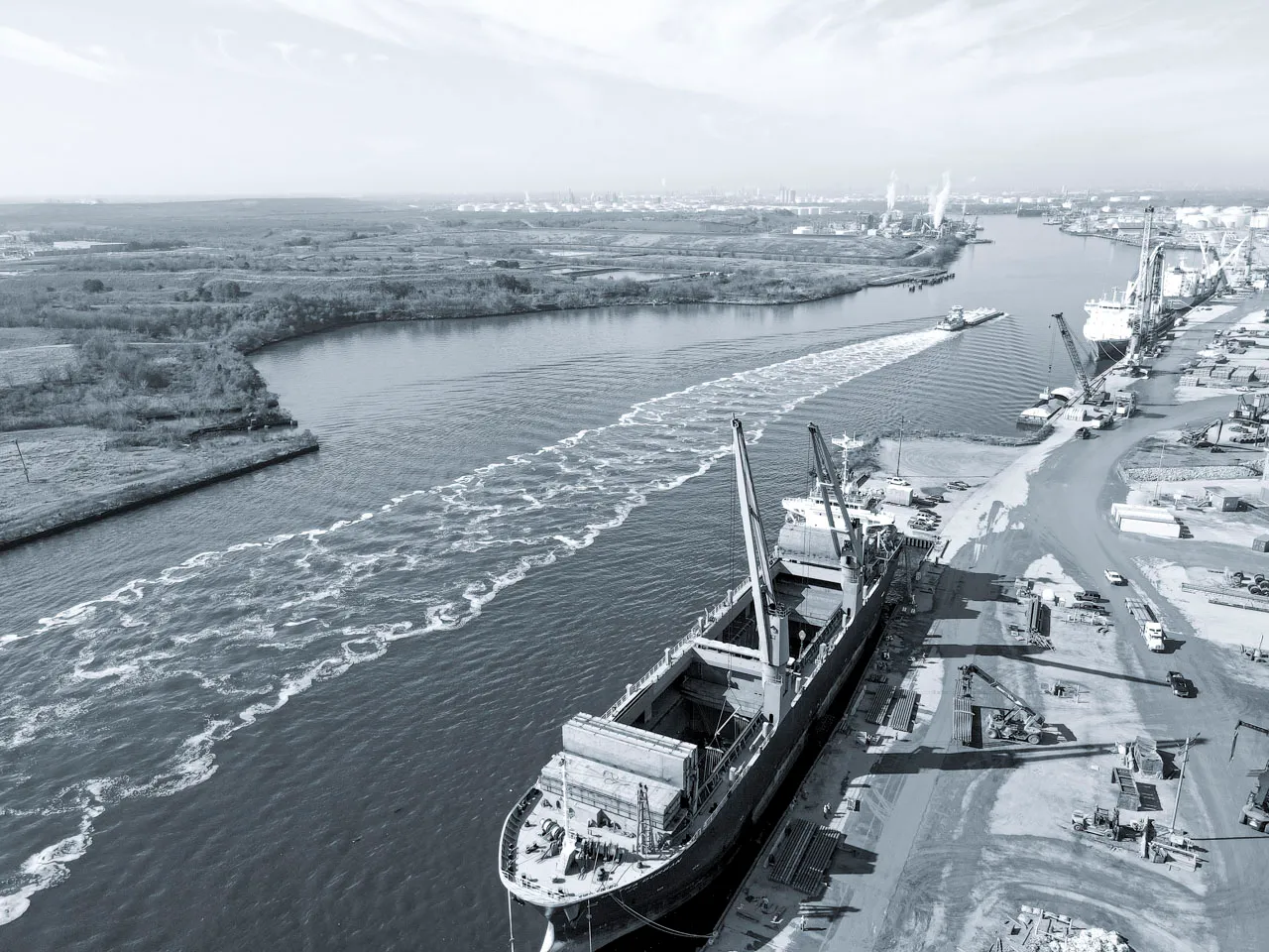 alt="Ocean freight vessel navigating through a commercial shipping canal: Illustrating global trade routes and KOGA Shipping's international logistics connectivity.