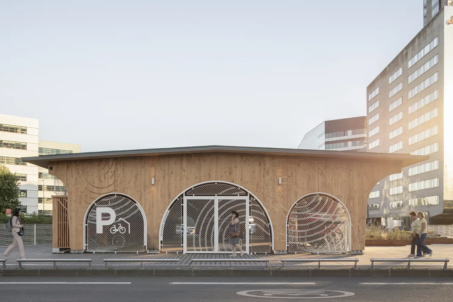 It started as a simple program and grew into a complex project: a bicycle station with a wooden structure, clad in wood and metal, and topped with a green roof. Located at the intersection of train stations, public transport and the ring road, it reconnects slow, active mobility with a dense urban network. By emphasizing pedestrians and soft traffic flows within a car- and train-dominated environment, the project restores balance and redefines the role of human-scale movement in the city.