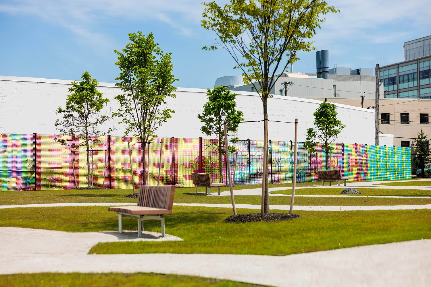 “Dotted Sequences” uses over 56,500 3D recycled plastic dots, spanning 1,500 square feet of fence and transforms complex genetic science into bold, accessible public art.