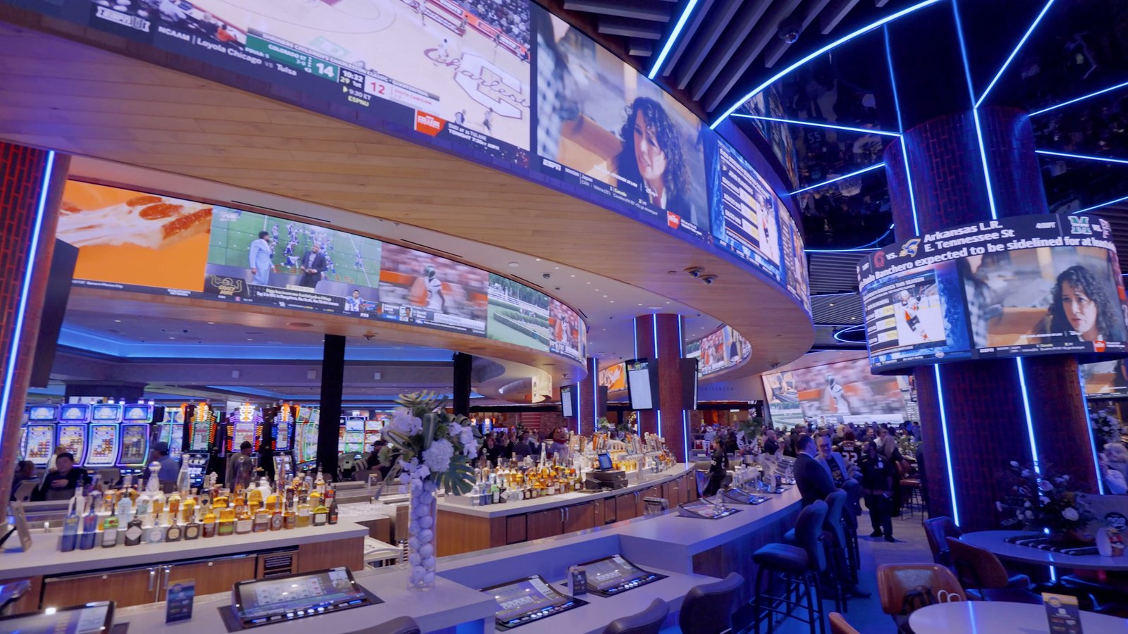 The curved LED ribbon wrapping the 909 Sportsbar at Yaamava&rsquo;, carrying live games and odds above the bar