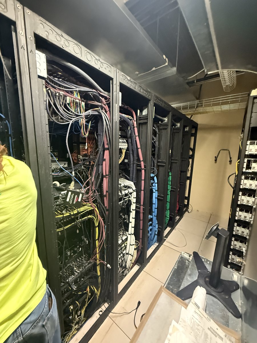 Legacy server racks with dense cabling in Aliante&rsquo;s rack room before LUCI consolidation