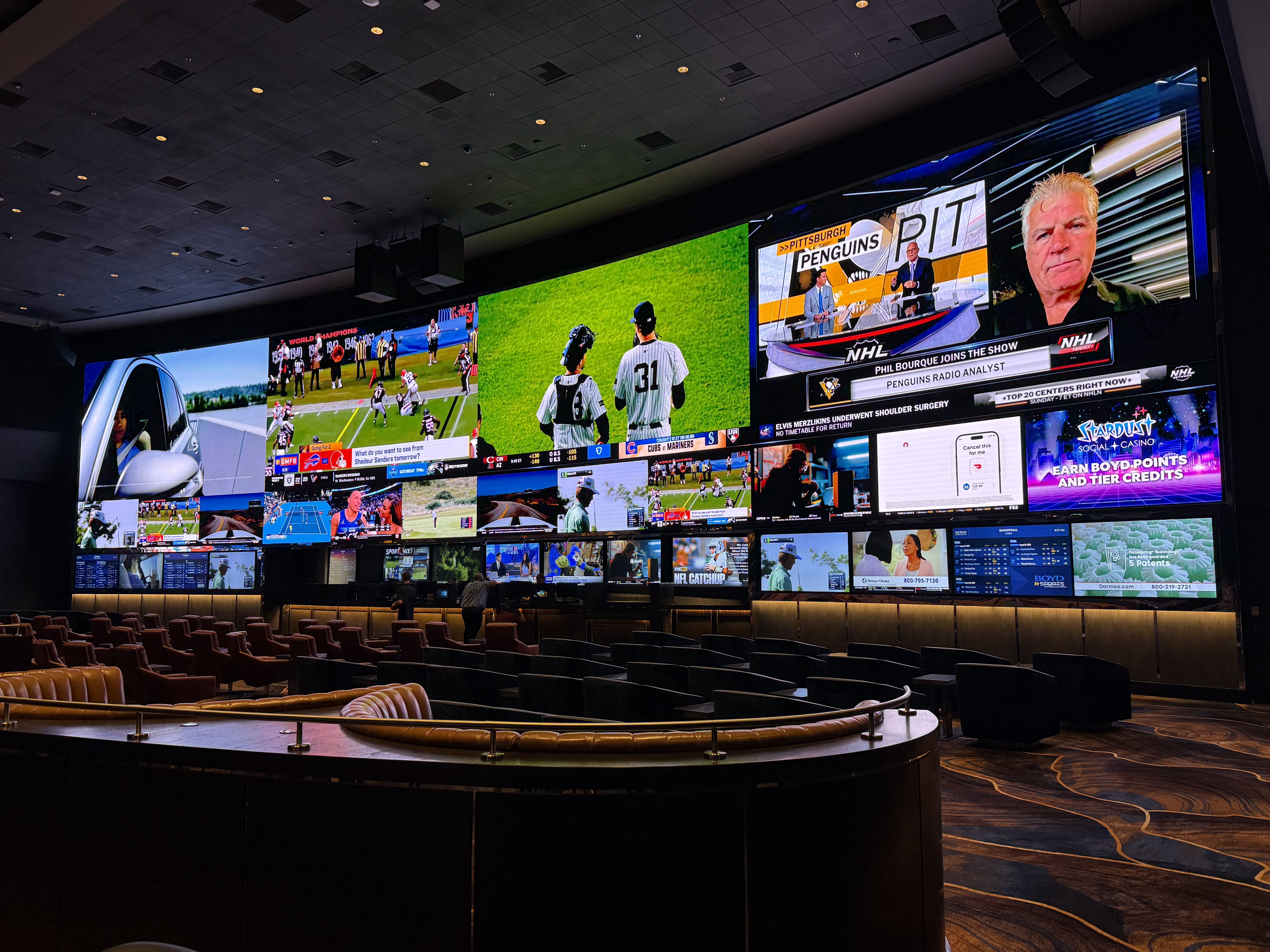 Aliante sportsbook after the remodel &mdash; 106-foot curved LED wall live with multiple sports zones and betting tickers