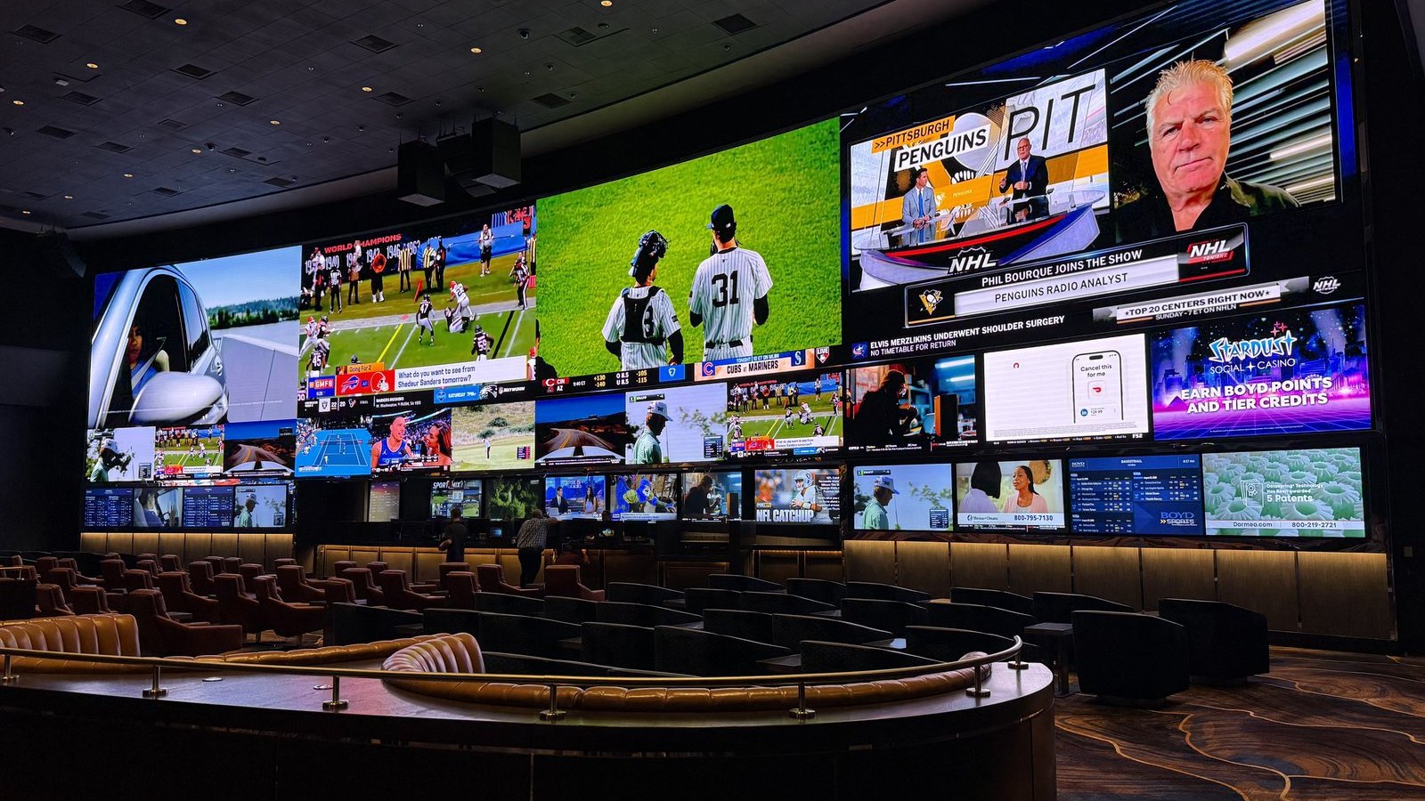 Aliante sportsbook after the remodel &mdash; 106&rsquo; x 20&rsquo; curved LED wall live with multiple sports zones and betting tickers