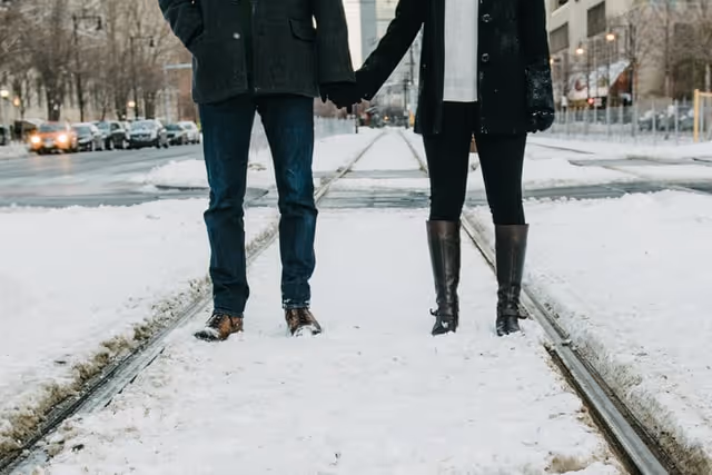 Couple holding hands in the snow