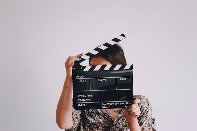 Woman behind clapper board