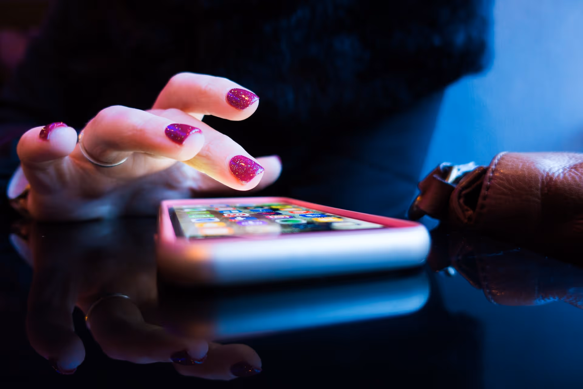 Hand hovering over a smartphone screen