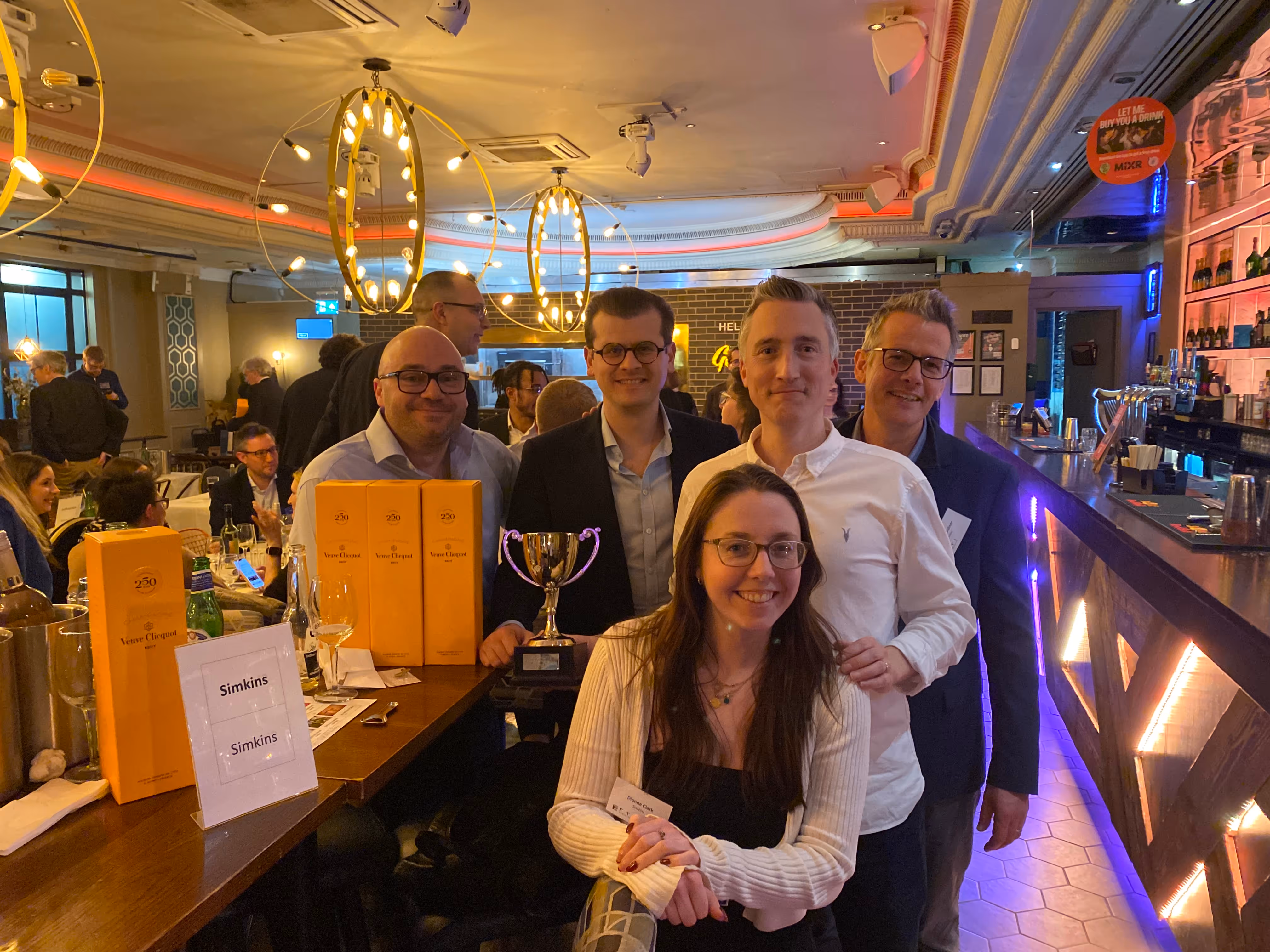 Simkins' winning quiz team with champagne