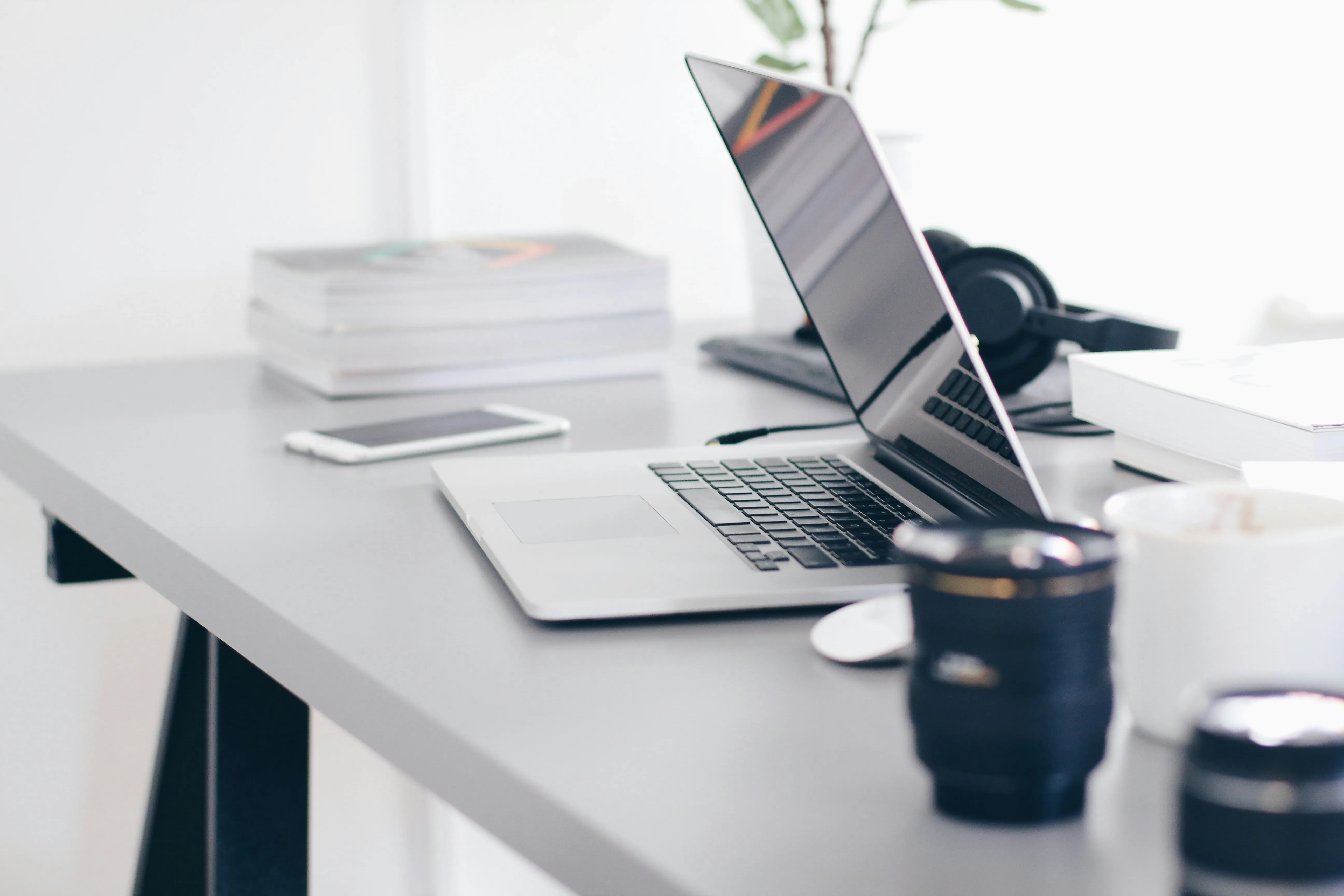 Two laptops and papers on a desk