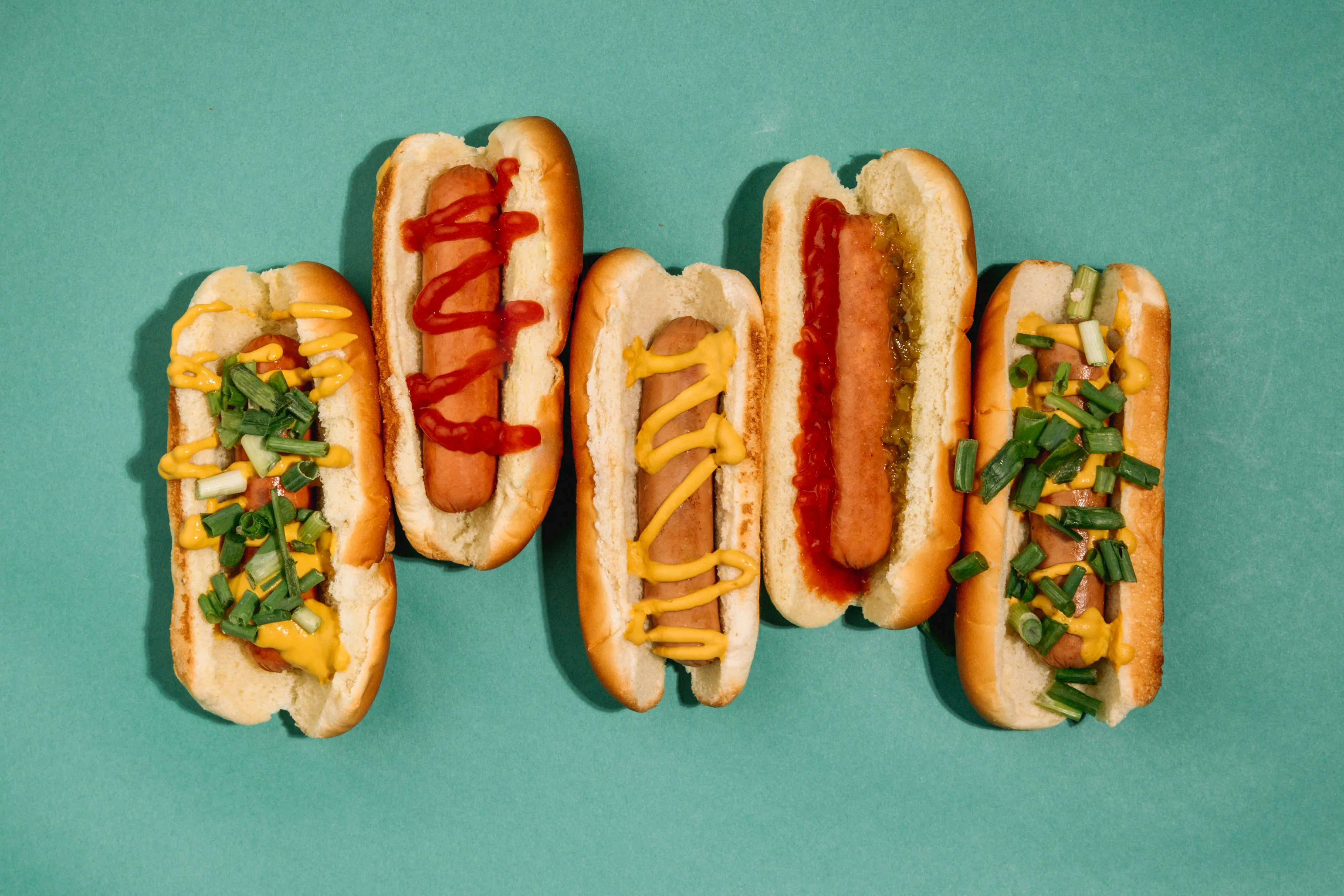 Hot dogs against a blue background.