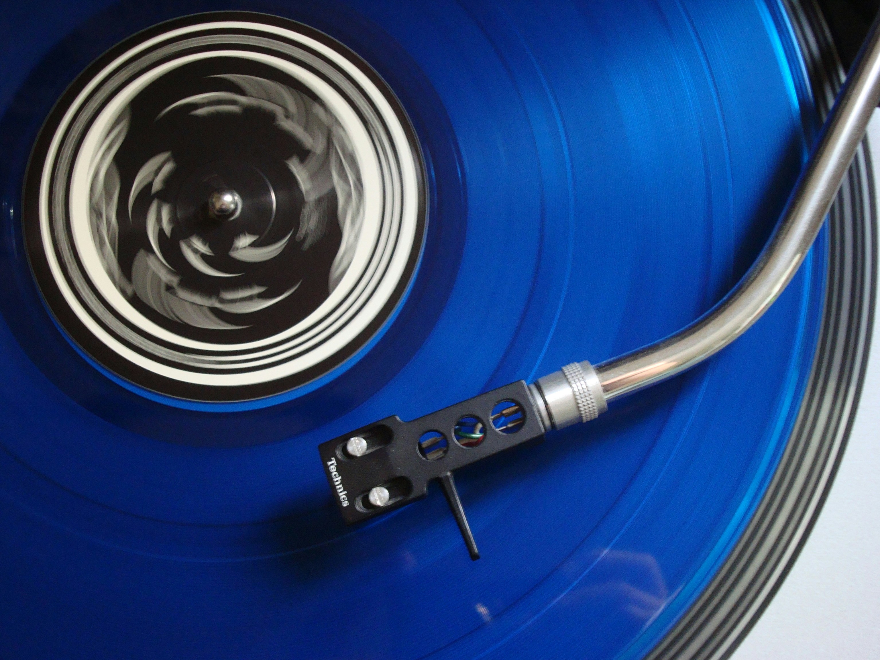 blue vinyl record and record player needle