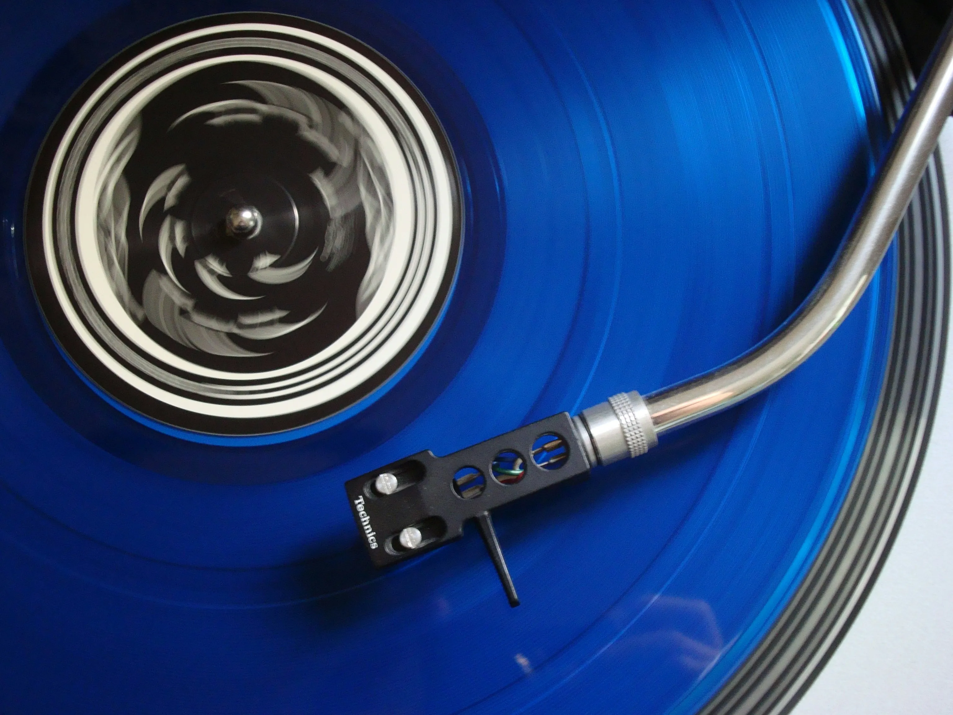 blue vinyl record and record player needle