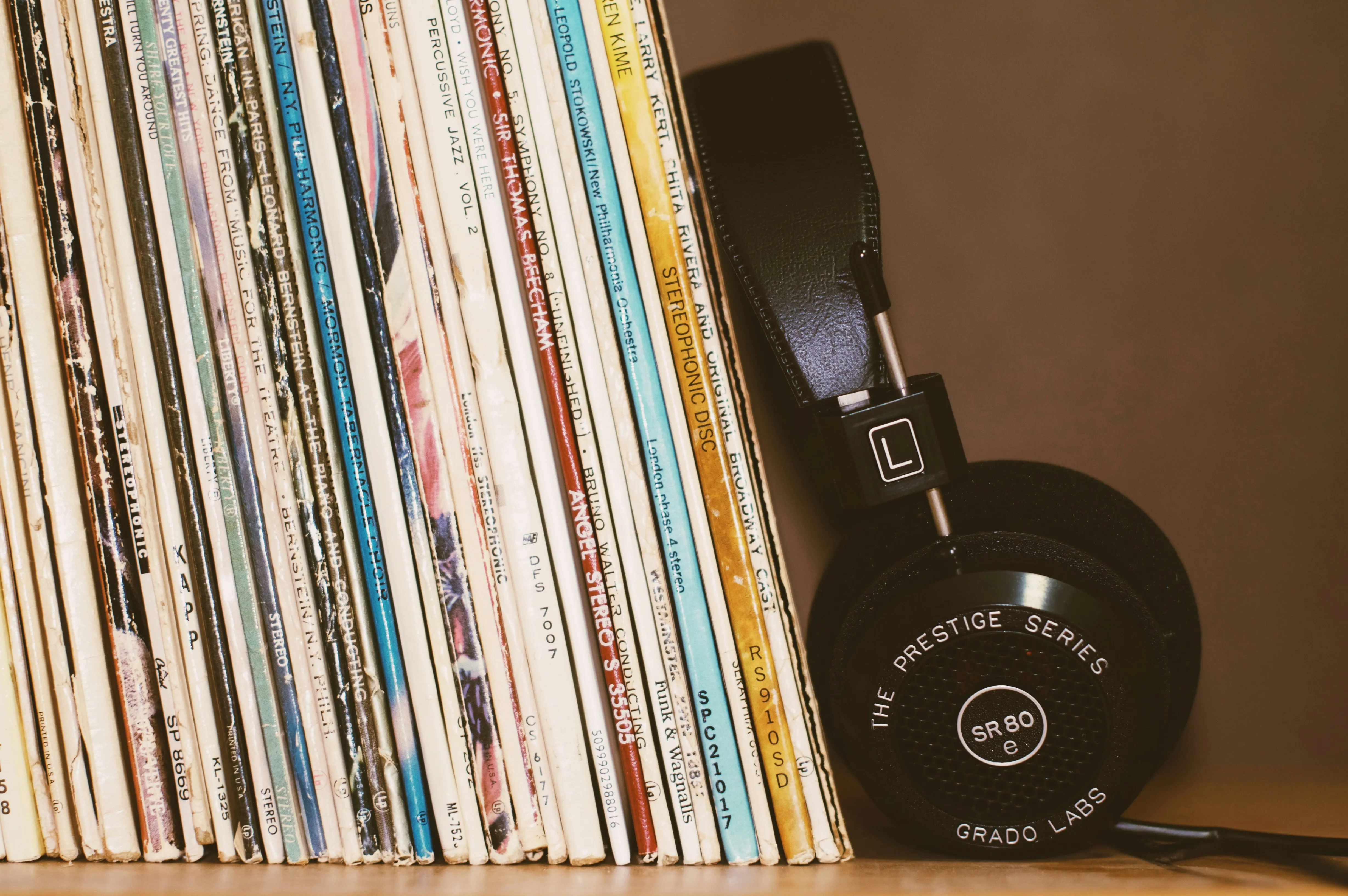 Records propped up by headphones on a shelf