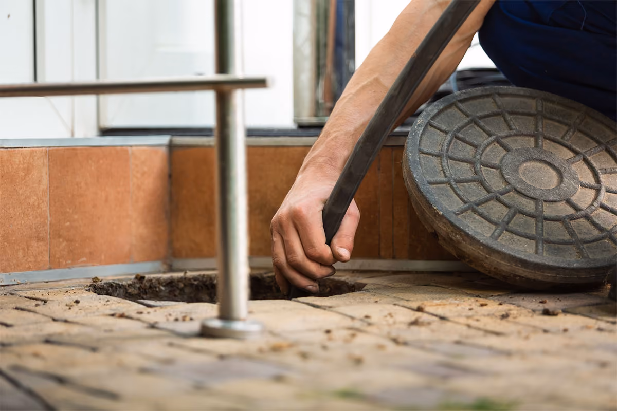 A plumber is performing sewer cleaning.