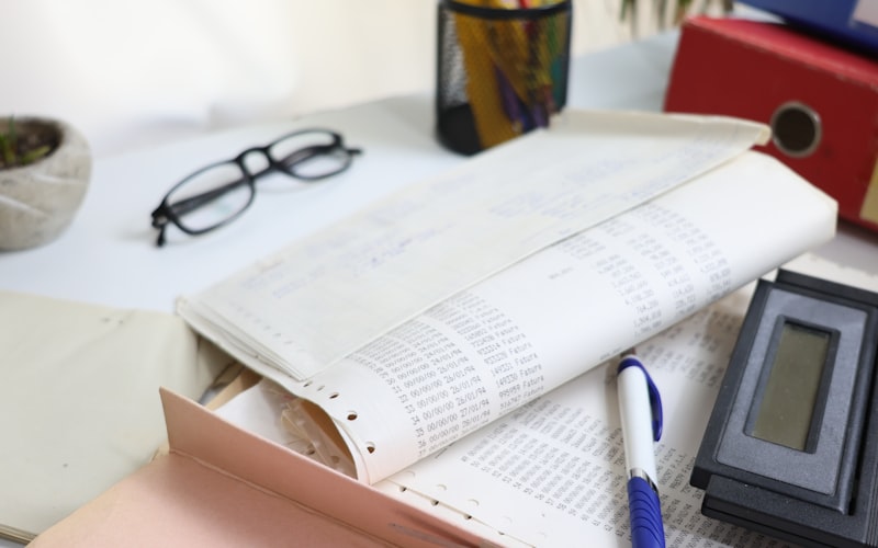 Financial documents and a calculator on an accountant's desk