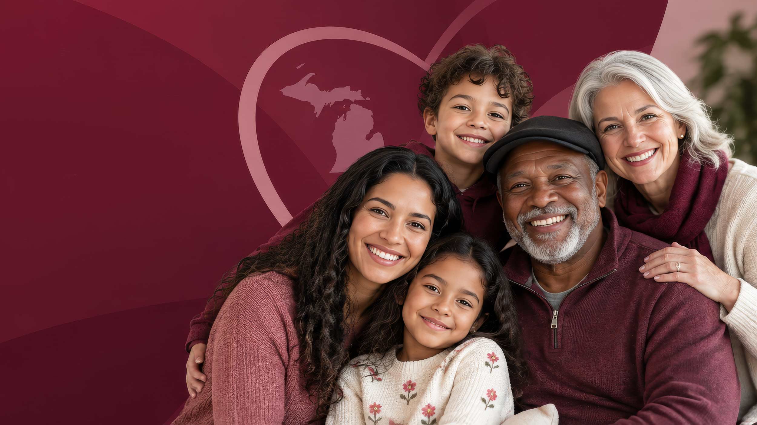 A multigenerational family with two children, a middle-aged woman, an elderly man, and an elderly woman smiling and posing together against a maroon background with a heart shape surrounding a silhouette of Michigan state.