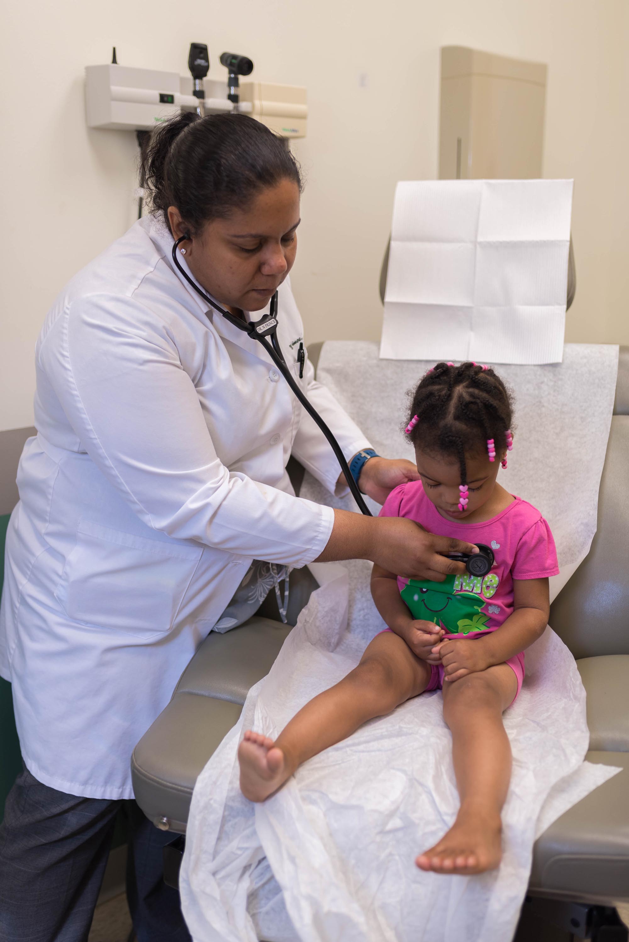 A pediatrician at a Covenant Community Care clinic performs a check-up on a young patient in Detroit, MI