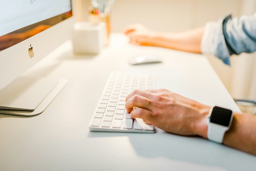 Photo of a hand typing at a keyboard