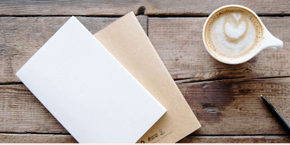 Notebook and pen on desk ready for writing project exclusions