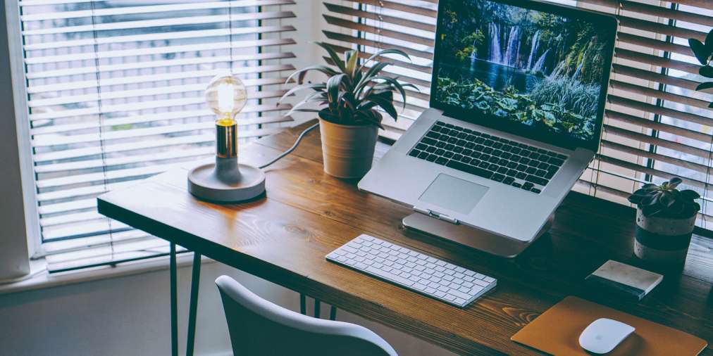 Desk workspace with notebook and laptop for marketing plan writing