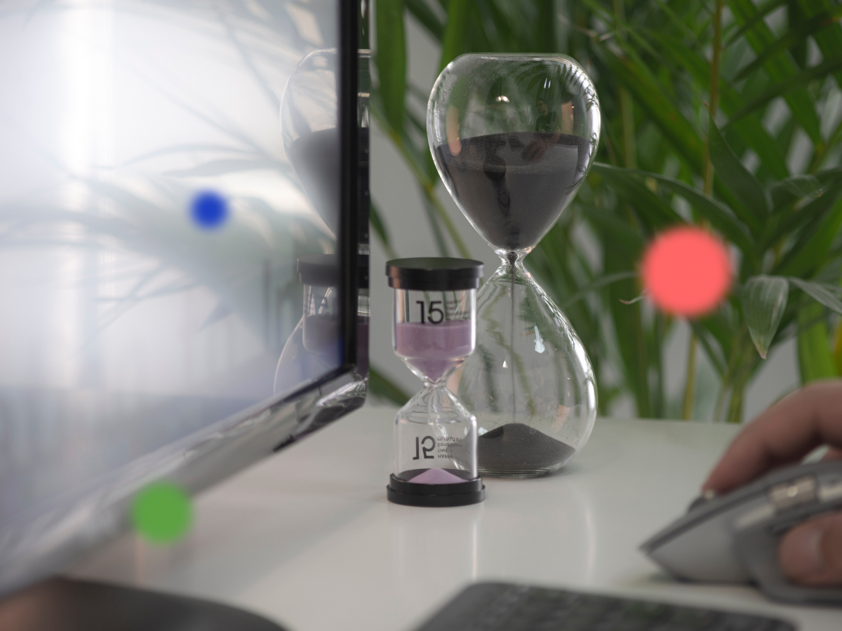 Hourglass on a desk representing time saved by working async