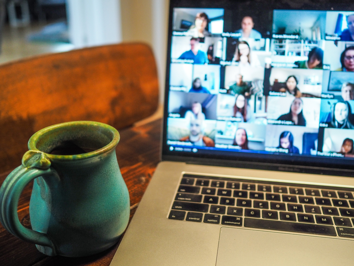 Remote team on a group video call shown on a laptop screen