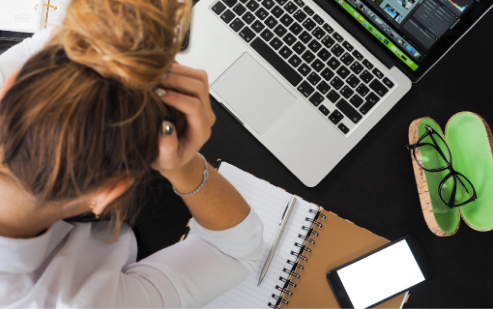 Remote worker at a laptop showing signs of screen fatigue