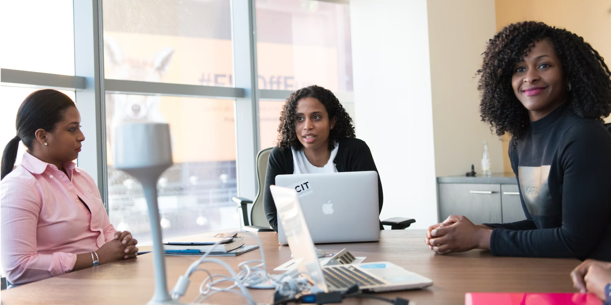 Group of professionals engaged in a remote team meeting around a table