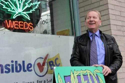 Don Briere standing in front of his Burrard Street Location with Sensible BC banner behind.