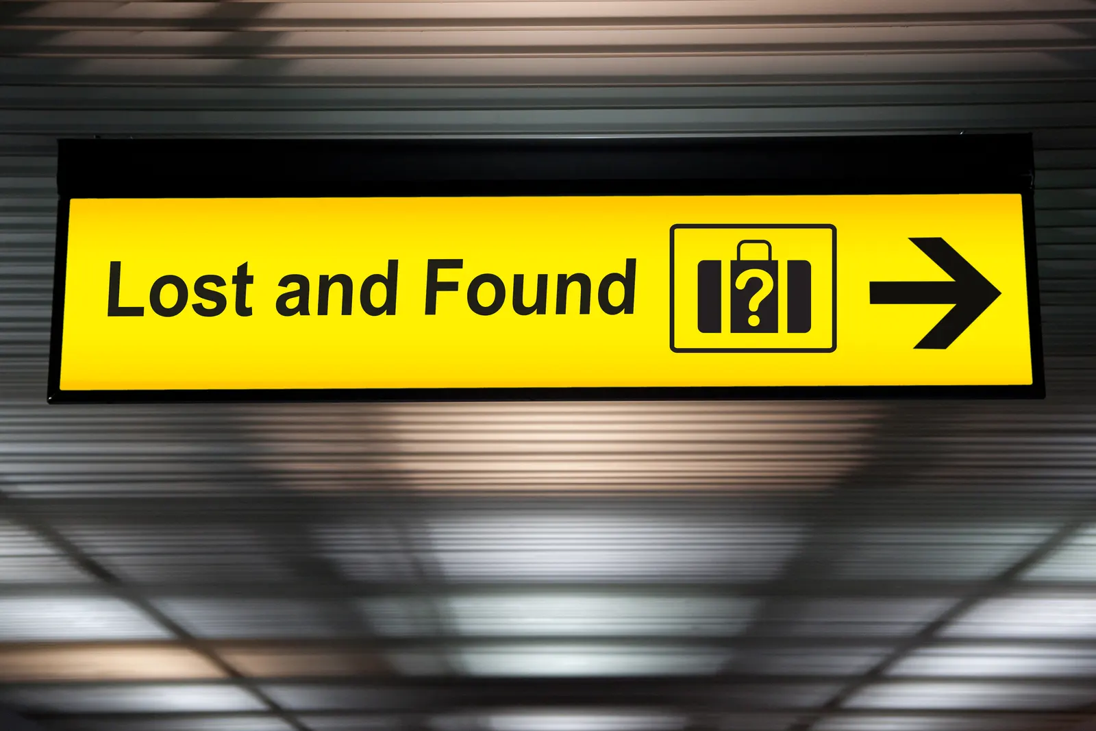 Picture of a sign from the airport which reads "Lost and Found" point an arrow towards the right dirrection.
