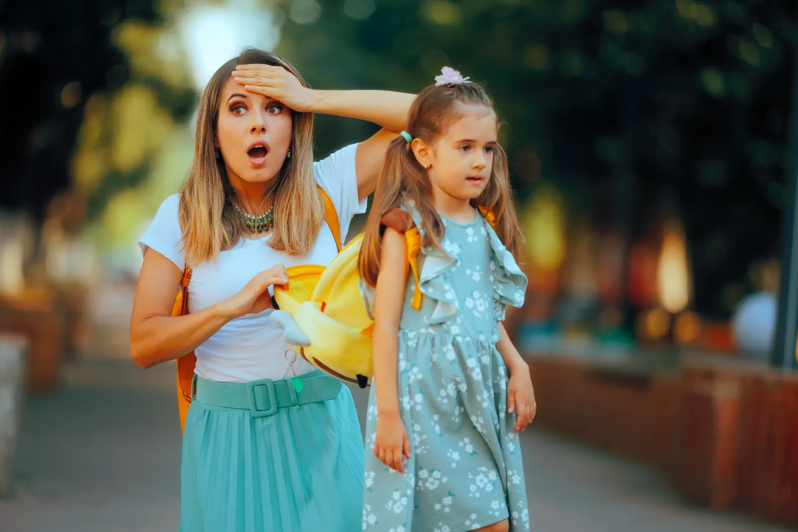 picture of a mother with her daughter, checking her schoolbag and realised she forgot something
