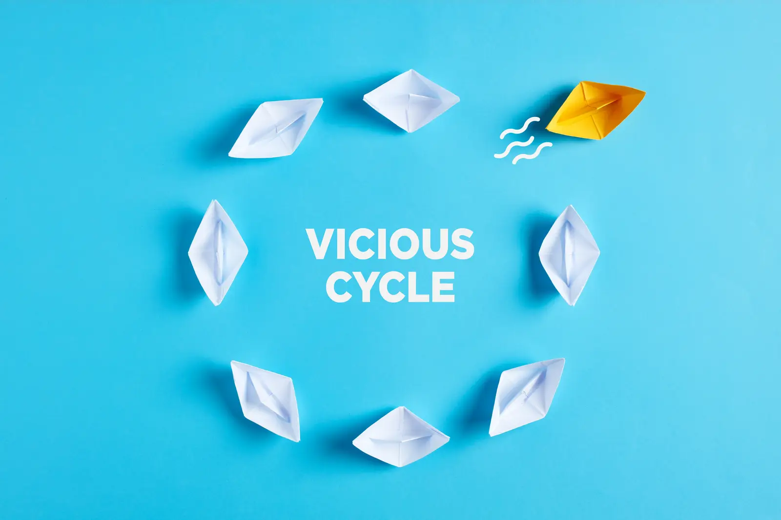 picture describing how to break a vicious cycle by departing old patterns and be different in this case representated by a different colour of the boat in yellow compared with the rest beeing white sitting in a circle