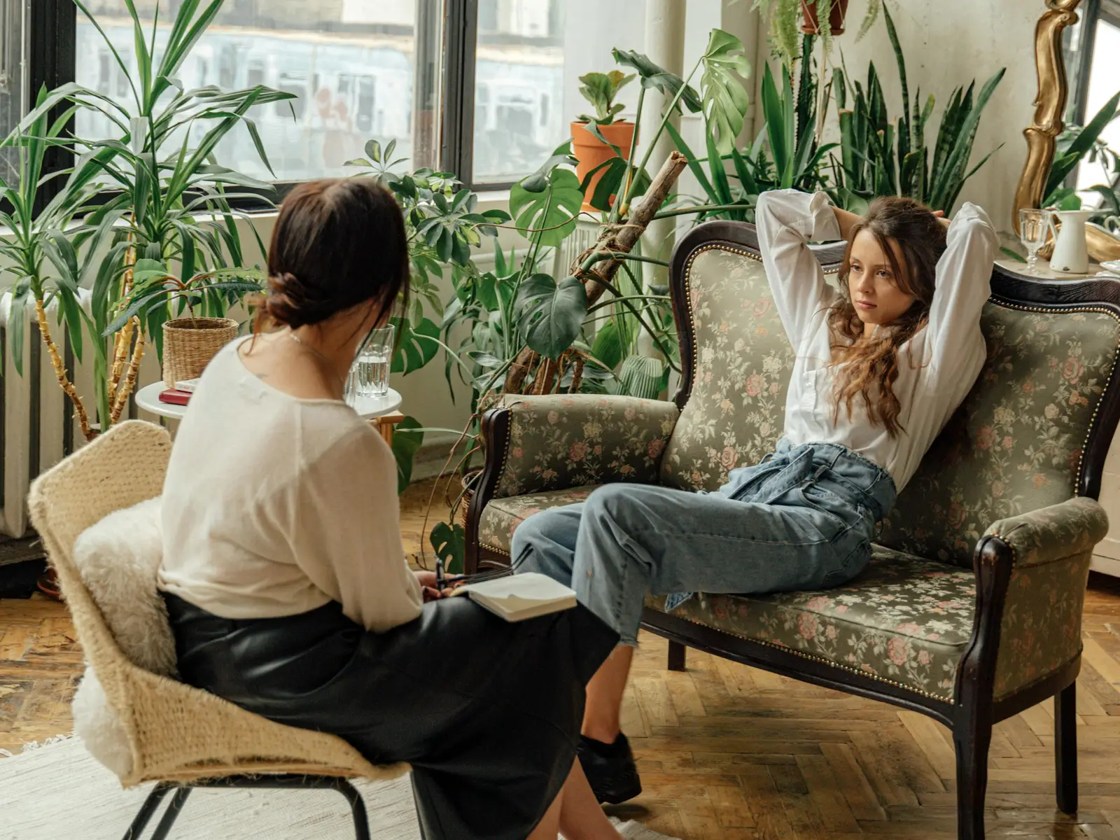 picture of a psychologist and a client in a therapy session in a very cosy upmarket office