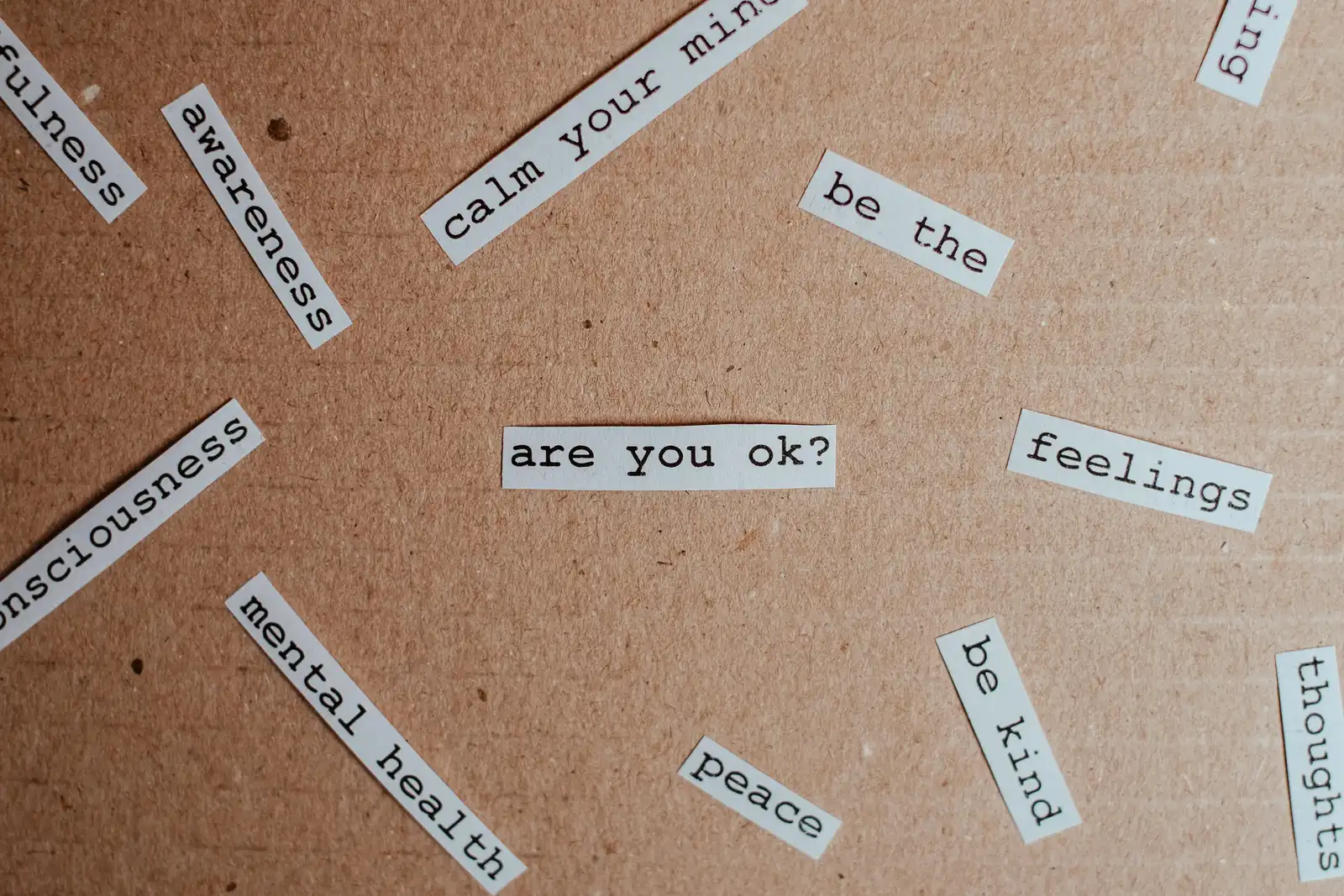 picture with notes on a wood wall, with encouraging messages for mental health