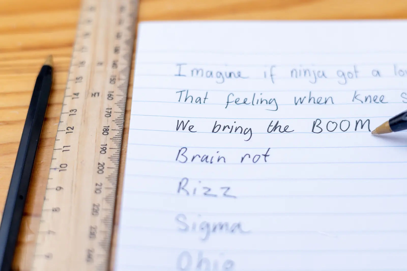 picture of gen z slangs, handwriting on a notebook