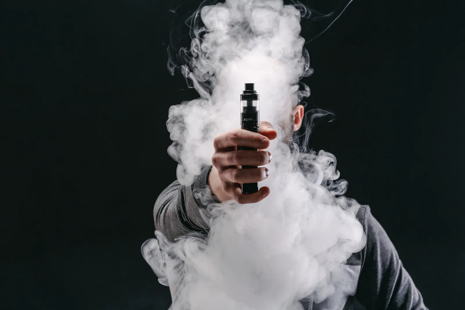 Picture of a man covered in smoke from vaping suggesting this activity can be dangerous to health and wellbeing.
