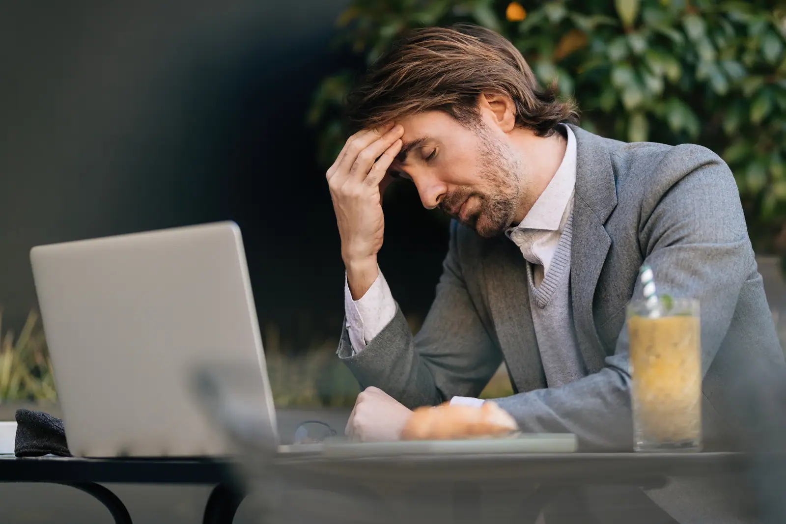 Stressed high achiever, wearing a suit with an undiagnosed neurodiverse condition