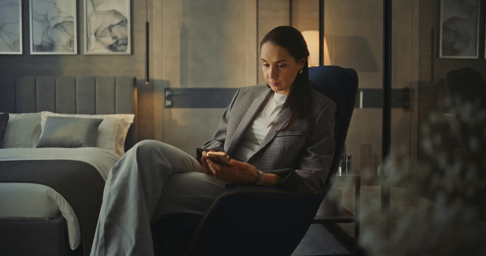 picture of a woman wearing smart clothes worried for the future while holding a mobile phone