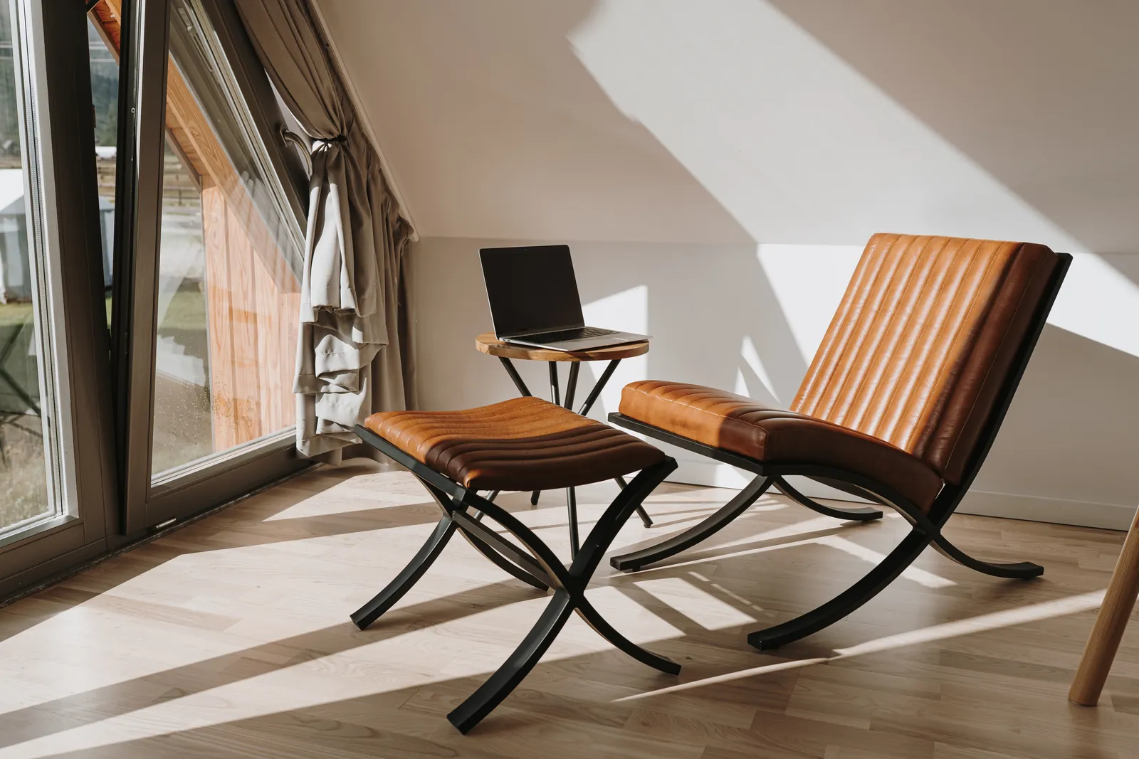 Aesthetic luxury modern consulting office interior with orange leather armchair in warm sunlight