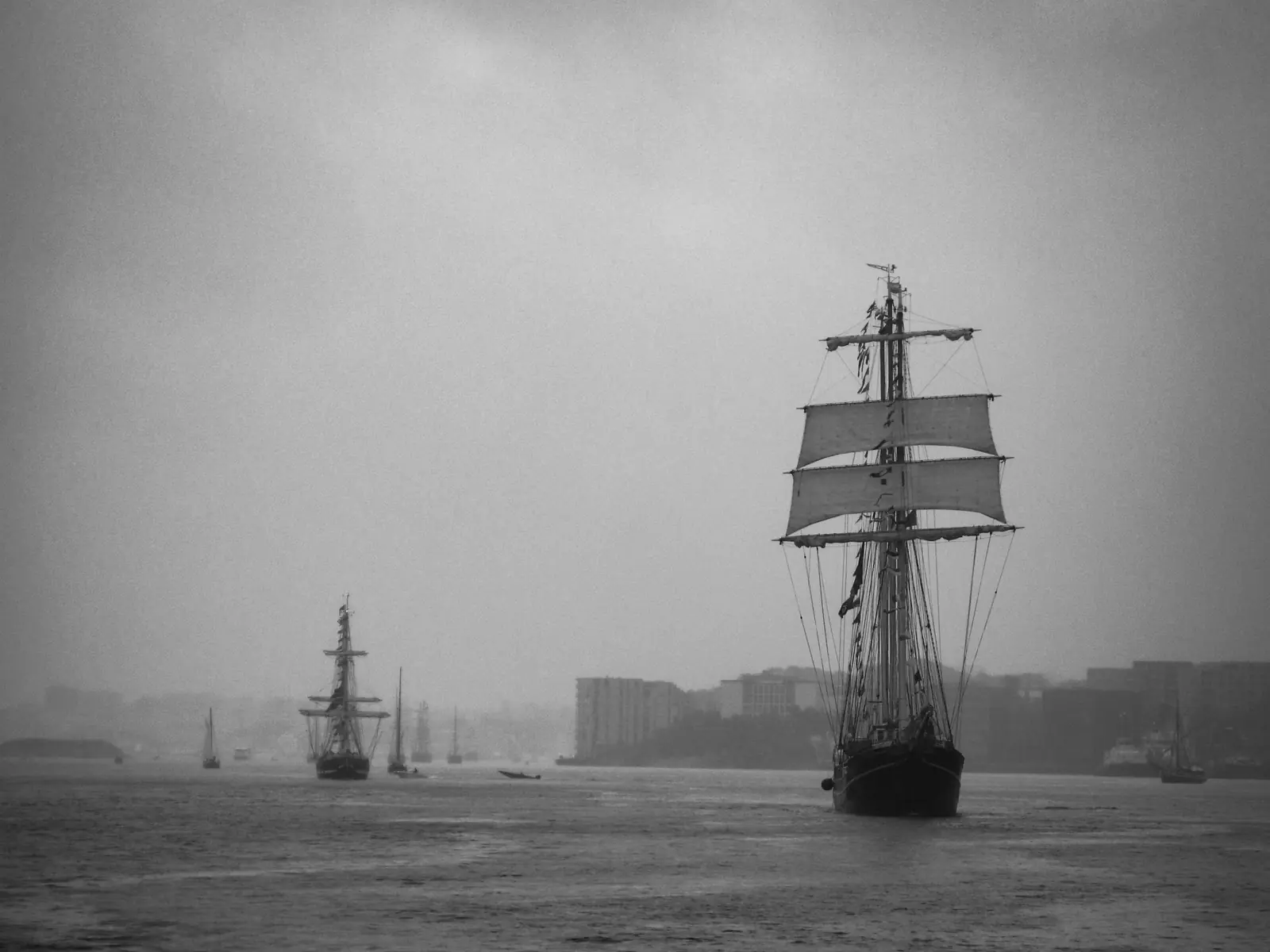 Black and white picture of sail ships having different strategies navigating the unknown territory. 