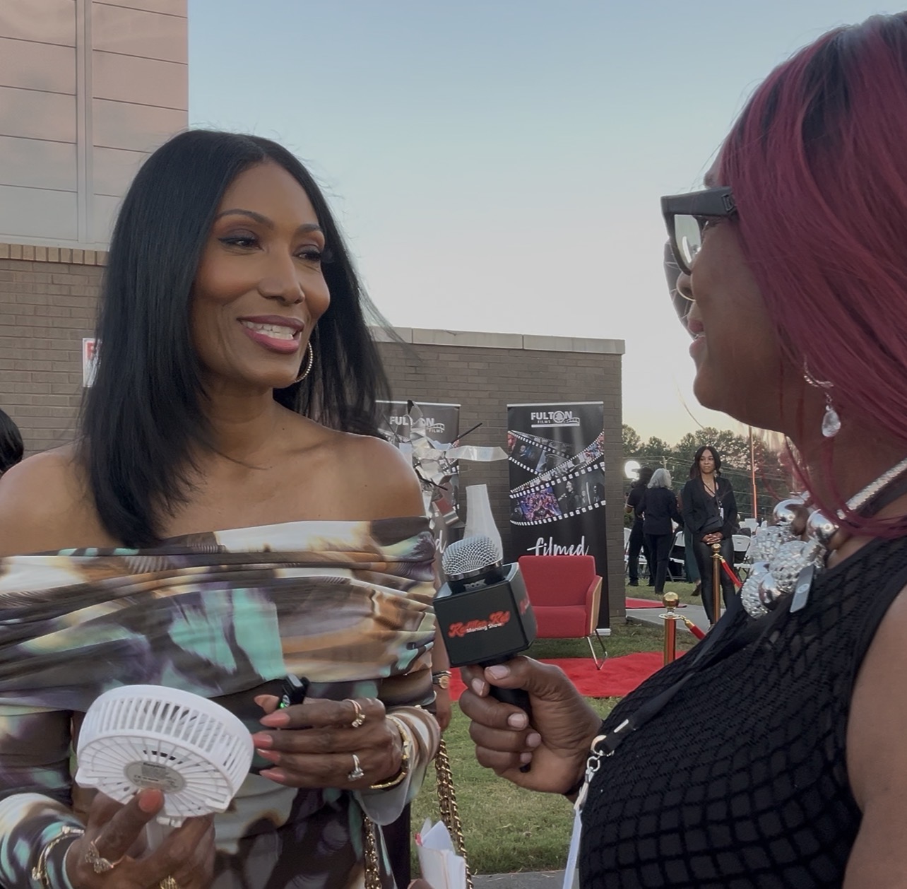 Kadillac Kat interviewing a guest on the red carpet