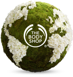 The Body Shop Earth Day sustainability logo on a globe with floral and moss elements