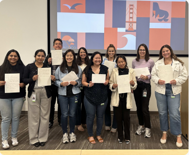 A large group of volunteers holding certificates